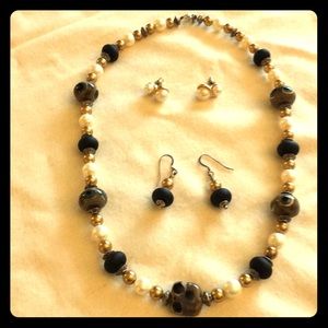 29” necklace with 2 pair of matching earrings.